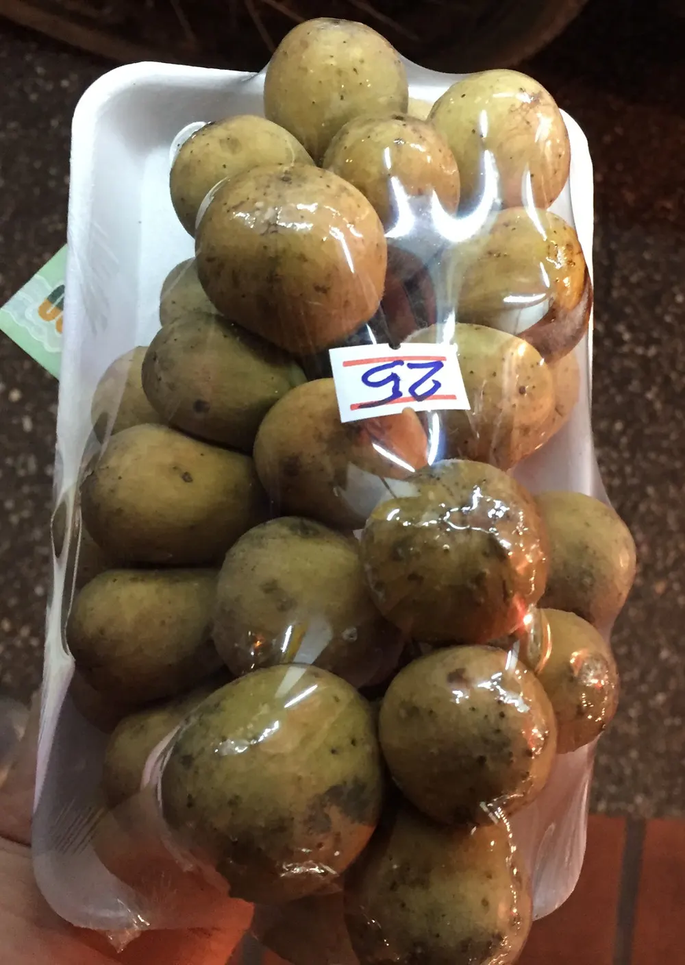a 25 baht package of longkong or longan from a chiang mai night market in thailand