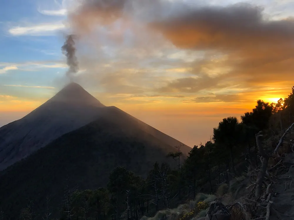 The Acatenango Volcano erupting at sunset near Antigua Guatemala