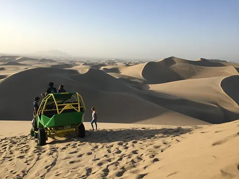 Sanboarding ATV trip through the sand dunes in Huacachina Peru