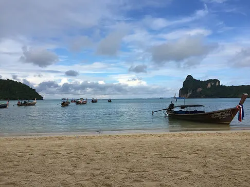 traditional Thai boats on a beach in Phuket, Thailand