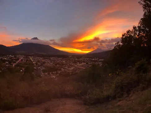 the mirador viewpoint overlooking Antigua Guatemala and Volcan Fuego during sunset