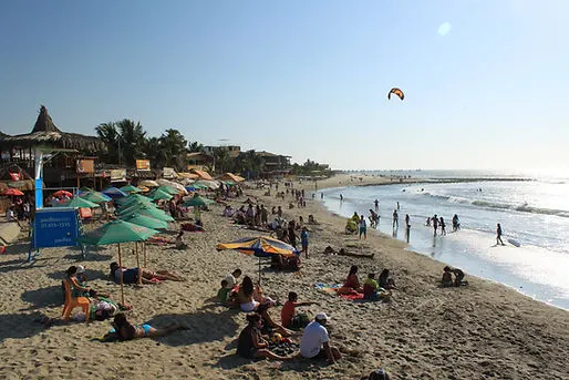tourists enjoying the beach in Mancora, Peru