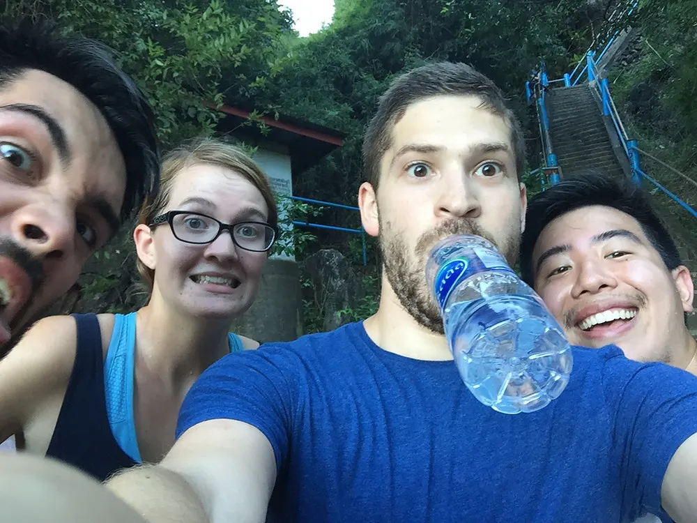 a group of american and Canadian hikers climbing all 1237 steps to the top of the Tiger Cave Temple in Krabi, Thailand