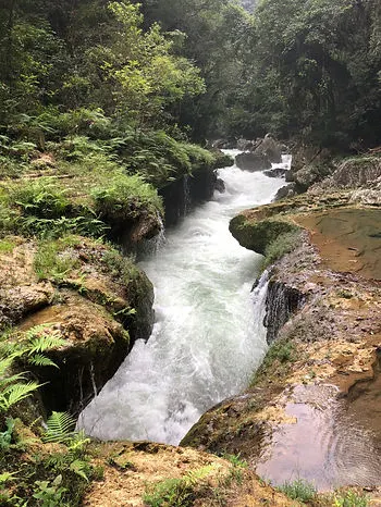 a river running through Semuc Champey in the Guatemala jungles