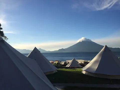 glamping tents at Free Cerveza hostel on Lake Atitlan with volcan fuego in the distance