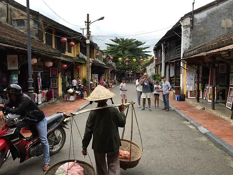Following a local Vietnamese man in the Old Town of Hoi An Vietnam