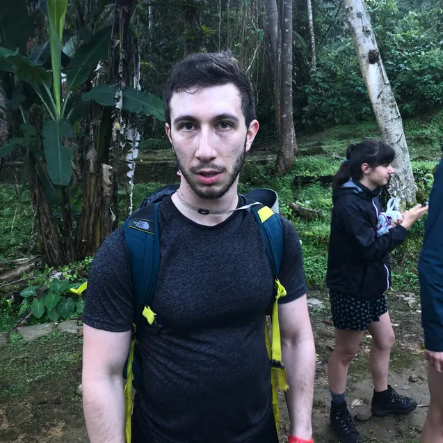 A tired American hiker in Colombia's Lost City Trek in the Santa Marta Region's jungle